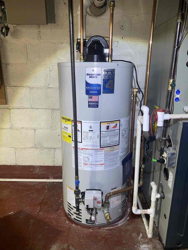 Replaced failed 50-gallon natural gas water heater due to leaking tank. Installed new Bradford White 50-gallon natural gas power-vent water heater with proper venting, copper supply line connections, pressure relief valve, and all required safety components per manufacturer specifications and local code requirements.