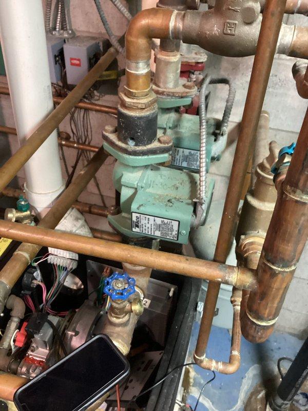 Completed annual heat inspection on 16-year-old boiler system as part of prepaid maintenance plan. System found in poor condition with significant deterioration evident throughout. Circulator pump showing advanced age with surface wear and discoloration on housing. Interior inspection revealed heavy corrosion, rust buildup, and oxidation throughout heat exchanger and flue passages. Copper piping displaying natural patina consistent with system age. All findings documented with photographs. Customer advised system requires repair or replacement due to extensive deterioration and safety concerns.