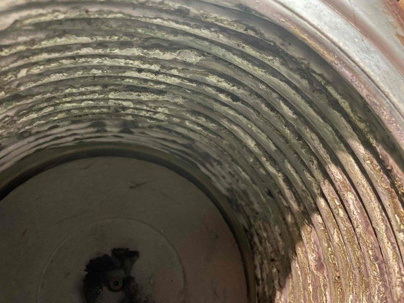 Completed annual heat inspection on 16-year-old boiler system as part of prepaid maintenance plan. System found in poor condition with significant deterioration evident throughout. Circulator pump showing advanced age with surface wear and discoloration on housing. Interior inspection revealed heavy corrosion, rust buildup, and oxidation throughout heat exchanger and flue passages. Copper piping displaying natural patina consistent with system age. All findings documented with photographs. Customer advised system requires repair or replacement due to extensive deterioration and safety concerns.