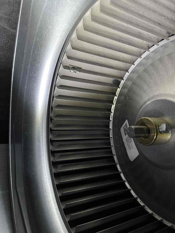 Completed Partner Plan annual heat inspection on 2-year-old furnace system. Inspected blower wheel assembly and confirmed proper operation; noted dust accumulation on squirrel cage fan blades. Discovered water leak on furnace exhaust system with visible staining on white PVC vent piping. Customer requested information regarding natural gas conversion for submission to WPS. Photographed blower assembly showing filter condition and exhaust leak evidence. Provided estimates for necessary repairs and conversion work.