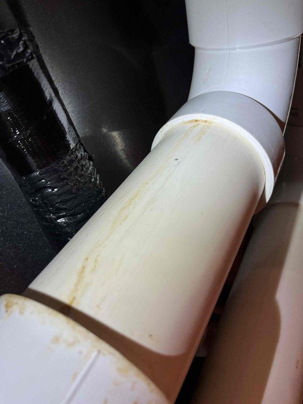 Completed Partner Plan annual heat inspection on 2-year-old furnace system. Inspected blower wheel assembly and confirmed proper operation; noted dust accumulation on squirrel cage fan blades. Discovered water leak on furnace exhaust system with visible staining on white PVC vent piping. Customer requested information regarding natural gas conversion for submission to WPS. Photographed blower assembly showing filter condition and exhaust leak evidence. Provided estimates for necessary repairs and conversion work.