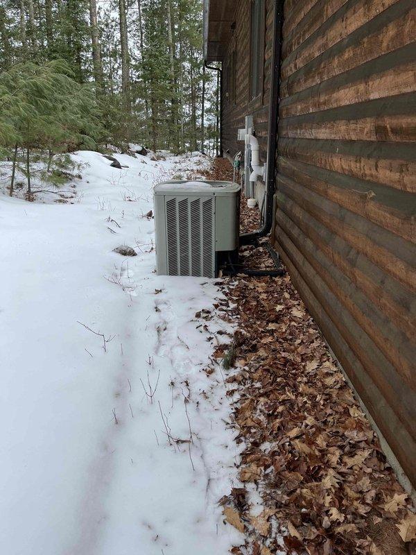 Completed annual inspection on furnace system at residential property with exterior heat pump unit. Found inducer motor and capacitor showing signs of wear and flagged as suspect components requiring monitoring or potential replacement. Verified brand new filter was properly installed and returned to correct position after inspection. Accessed property using lockbox system and documented equipment condition with photos showing outdoor HVAC unit in winter conditions with snow coverage.