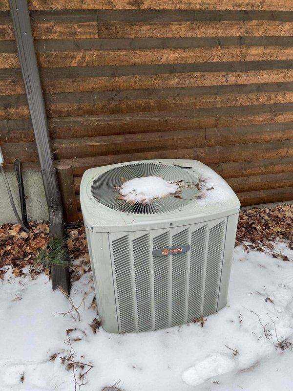 Completed annual inspection on furnace system at residential property with exterior heat pump unit. Found inducer motor and capacitor showing signs of wear and flagged as suspect components requiring monitoring or potential replacement. Verified brand new filter was properly installed and returned to correct position after inspection. Accessed property using lockbox system and documented equipment condition with photos showing outdoor HVAC unit in winter conditions with snow coverage.