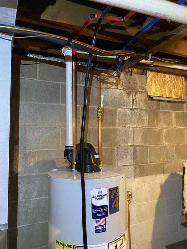 Successfully removed and disposed of existing water heater and installed a new 50-gallon Bradford White natural gas power-vent water heater in basement utility area. Connected all supply and discharge plumbing lines with proper shut-off valves, installed temperature and pressure relief valve with code-compliant discharge piping, and verified all gas connections for safe operation. Tested unit for proper ignition, venting, and temperature control, ensuring all manufacturer specifications and local plumbing codes were met upon completion.