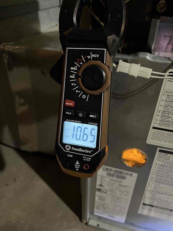 Responded to service call for furnace with intermittent heating and repeated shutdowns occurring over several years. Performed diagnostic testing revealing inducer motor drawing high amperage (7.18A and 10.65A measured), corroded flame sensor and igniter assembly, and potential backdraft condition affecting safe operation. Documented equipment condition with photos and provided repair estimates; comfort advisor scheduled to discuss replacement options with customer.