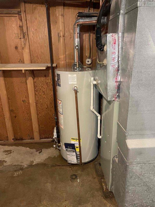 Installed a 40-gallon Bradford White natural gas atmospheric vent water heater in basement location. Installed new shutoff valve on cold water supply line and connected copper water piping to unit inlet and outlet connections. Connected water heater flue to existing natural draft vent system and utilized existing gas shutoff valve to connect gas piping to the appliance. All connections were tested and verified operational upon completion.