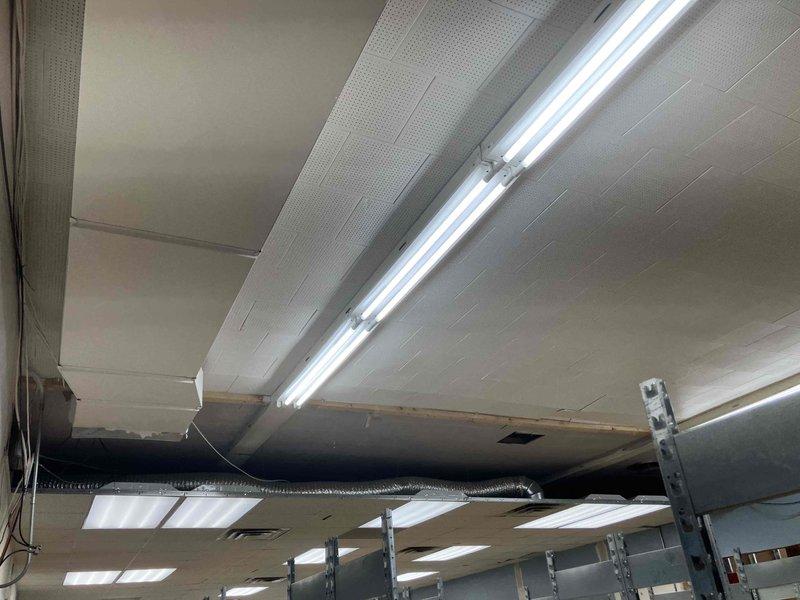 Performed system balance test and airflow evaluation following office wall removal in commercial space. Inspected HVAC ductwork and identified missing return air grill where wall was previously located. Documented ceiling-mounted ductwork configuration and system layout with photos. Provided estimate for airflow testing and return grill installation to ensure proper system operation and balance as required by inspector.