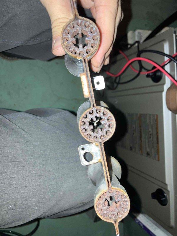 Performed annual inspection on 12+ year old furnace that had not been serviced in four years. Found condensate pump inoperative, burners heavily corroded with rust, and flame sensor with significant deterioration. Documented conditions with photos showing dust accumulation on blower wheel assembly and severely rusted burner components. Provided immediate repair and preventive maintenance recommendations to address safety and operational concerns.