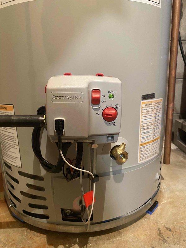 Installed a Bradford White 50-gallon LP power vent water heater in basement utility room. Performed minor alterations to existing water lines, gas line, and venting system to accommodate the new unit. Connected all plumbing and gas connections, installed ZCOV control system on top of tank, verified proper operation of temperature/pressure relief valve, and confirmed system functionality upon completion.