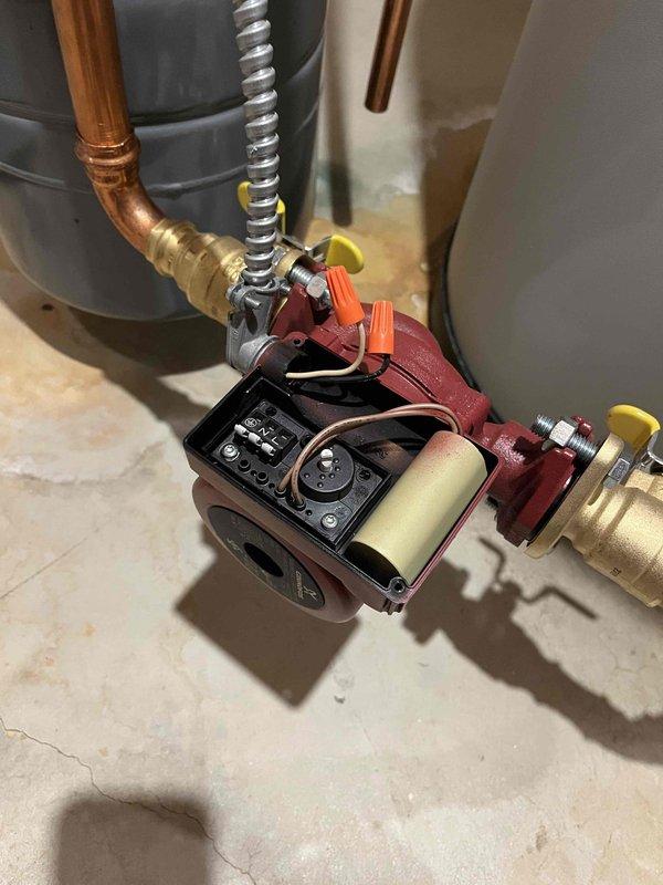 Responded to service call for leaking indirect water heater with heating fluid visible at top of unit. Upon inspection, identified fluid seeping from both the base of the tank and near the electronics box at the top, indicating a compromised internal heat exchanger. Locked out the unit immediately to prevent potential antifreeze contamination of the domestic water supply and provided replacement estimates to address the failed heat exchanger.