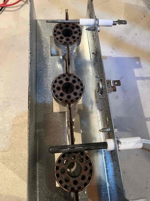 Responded to no heat call with flashing code indicating open pressure switch and limit switch issues. Upon inspection, found pressure switches failed for low fire operation, burners heavily corroded, compromised heat exchanger, and corroded flame sensor and igniter showing significant wear. Documented equipment condition with photos showing deteriorated burner assembly and failed flame sensor component, provided repair estimates, and coordinated with comfort advisor for replacement options.