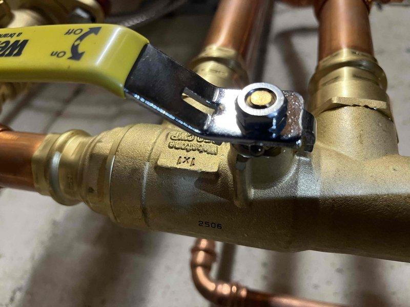 Responded to callback for recently installed boiler exhibiting leakage beneath unit. Upon inspection, identified seepage at packing nuts on new brass ball valves in supply piping system. Tightened packing nuts on affected valves to eliminate leaks and restore proper seal integrity. Verified no further seepage present after adjustment.