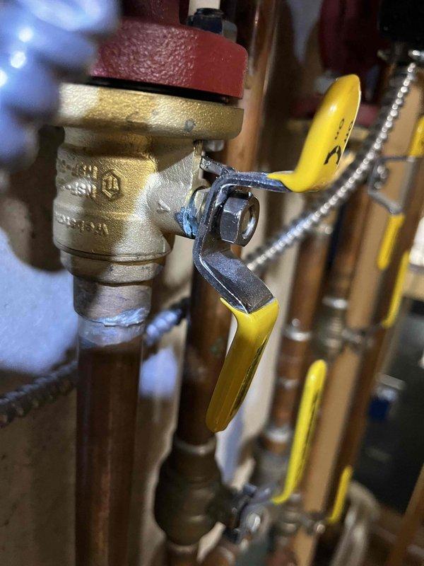 Responded to callback for recently installed boiler exhibiting leakage beneath unit. Upon inspection, identified seepage at packing nuts on new brass ball valves in supply piping system. Tightened packing nuts on affected valves to eliminate leaks and restore proper seal integrity. Verified no further seepage present after adjustment.