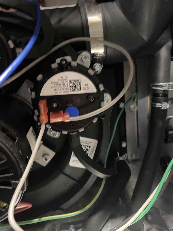 Responded to warranty call for HVAC system experiencing pressure switch failure. Removed and replaced defective pressure switch (part #9375VS-0033) with new unit, reconnected all electrical connections including blue, white, and green wiring to proper terminals, and verified secure mounting and proper operation of replacement component. Recommend follow-up inspection of condensate drain trap during next service visit to ensure proper drainage and prevent future system issues.