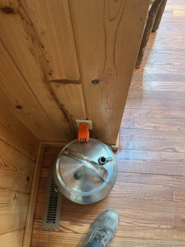 Completed electrical prepaid inspection of property. Accessed premises using key from lockbox located under electrical box on west side of garage. Performed comprehensive electrical system evaluation and identified two items requiring attention. Documented findings with photographs showing interior wood-paneled structure with smoke detector installation and floor-level electrical components including metallic cylindrical device with visible mechanical connections. Provided customer with detailed options for addressing identified electrical concerns.