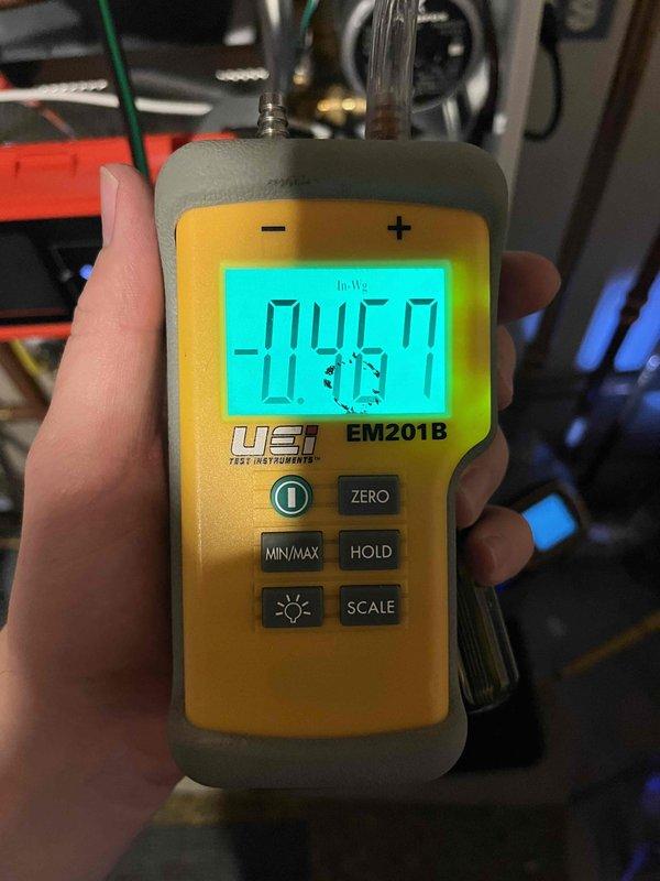 Completed Partner Plan annual maintenance inspection on boiler system. Found combustion levels outside of manufacturer specifications and performed necessary adjustments to bring all readings back within proper parameters. Verified system operation and documented equipment condition with photos showing heat exchanger assembly and pressure measurements using calibrated digital manometer reading -04.67 inches of water column.