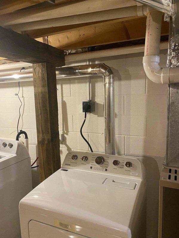Installed approximately 20 feet of new dryer vent ducting in basement laundry area, including two elbows and exterior dryer vent hood. Routed metallic ductwork along ceiling joists from dryer location to exterior wall penetration, securing all connections per manufacturer specifications. Completed installation ensures proper venting and code compliance for dryer operation.