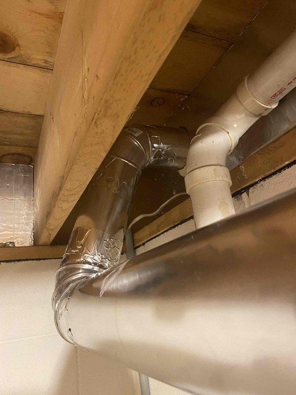 Installed approximately 20 feet of new dryer vent ducting in basement laundry area, including two elbows and exterior dryer vent hood. Routed metallic ductwork along ceiling joists from dryer location to exterior wall penetration, securing all connections per manufacturer specifications. Completed installation ensures proper venting and code compliance for dryer operation.