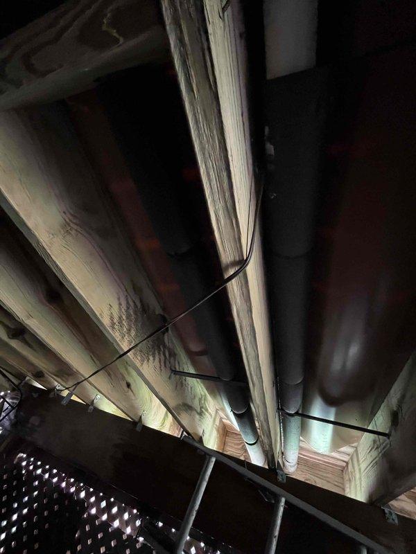Responded to callback for recent furnace and AC installation regarding uneven temperature distribution throughout the home. Found basement heat outlet vents fully closed, causing cold conditions on lower level while upper level was overheating. Adjusted airflow by partially opening basement vents, leaving main level vents unchanged, and restricting heat flow to upper level vents. Performed diagnostic testing including static pressure and heat rise measurements at both high and low fire settings to verify system performance. Applied insulation to exposed exterior vent piping from furnace that was previously left unprotected.