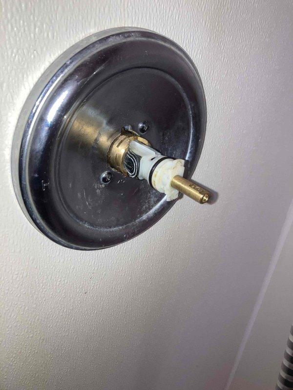 Completed de-winterization service on cabin plumbing system with no power available. Restored water supply to the property and inspected plumbing fixtures for proper operation. Noted significant rust and mineral buildup in toilet tank and partially disassembled shower valve requiring handle reinstallation upon completion of water restoration.