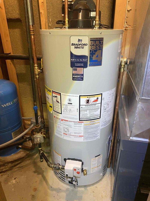 Removed and disposed of existing water heater and installed new Bradford White 50-gallon power vent water heater with natural gas connection. Installation included new cold water control valve and complete water and vent piping alterations to accommodate power vent configuration.

Removed existing pressure tank system and installed WX-202 20-gallon Well-X-Trol pressure tank with tank tee assembly featuring union connection, pressure gauge, pressure switch, drain valve, and sample faucet. Installed new building control valve and completed all necessary piping alterations to integrate pressure tank with existing well water system.

Removed and disposed of two existing toilets. Installed two Kohler Gleam skirted toilets with round front bowls in white finish, each equipped with plastic seat and new flexible supply line connections. All plumbing connections tested and verified for proper operation and leak-free performance upon completion.