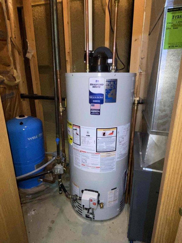 Removed and disposed of existing water heater and installed new Bradford White 50-gallon power vent water heater with natural gas connection. Installation included new cold water control valve and complete water and vent piping alterations to accommodate power vent configuration.

Removed existing pressure tank system and installed WX-202 20-gallon Well-X-Trol pressure tank with tank tee assembly featuring union connection, pressure gauge, pressure switch, drain valve, and sample faucet. Installed new building control valve and completed all necessary piping alterations to integrate pressure tank with existing well water system.

Removed and disposed of two existing toilets. Installed two Kohler Gleam skirted toilets with round front bowls in white finish, each equipped with plastic seat and new flexible supply line connections. All plumbing connections tested and verified for proper operation and leak-free performance upon completion.