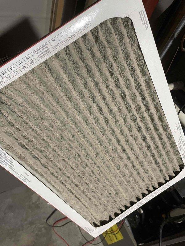 Responded to no heat call on 15-year-old furnace operating intermittently. Upon inspection, discovered heavily soiled air filter restricting airflow and plugged burners with clogged orifices preventing proper ignition. Identified failed draft inducer motor with severely rusted pulley and drive shaft showing extensive corrosion from prolonged moisture exposure. Replaced draft inducer motor assembly and cleaned burners and orifices to restore proper gas flow and combustion. Recommended air handler replacement due to age and deteriorated condition of components, but customer declined at this time. System restored to operational status with improved airflow and proper heating function.