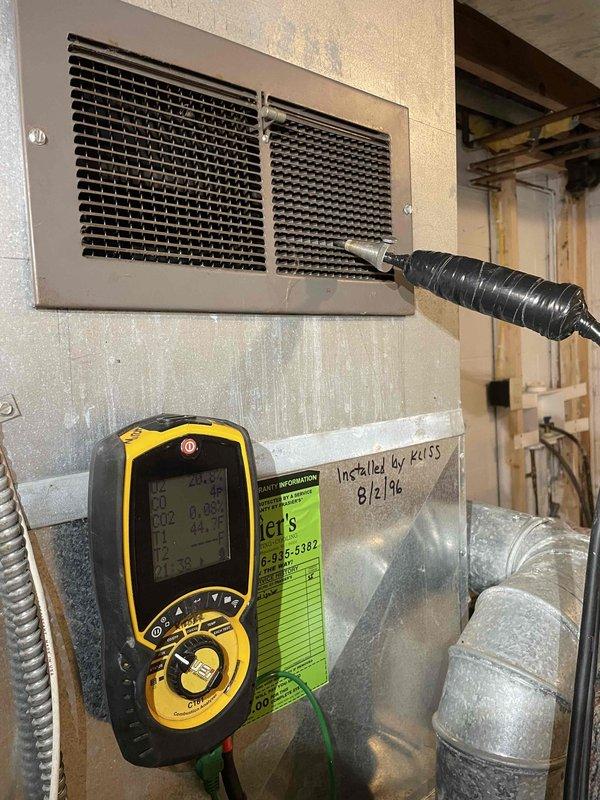 Responded to emergency no-heat call for 20+ year old furnace at summer home with reported water leaking and unusual sounds. Upon inspection, discovered failed heat exchanger with visible cracks causing combustion gas leakage, water intrusion from deteriorated chimney flashing, and damaged electrical connections due to moisture exposure. Documented extensive corrosion on heat exchanger coils and yellowing insulation indicating prolonged heat stress and age-related deterioration. Performed combustion analysis and safety testing confirming unit unsafe for operation. System remains shut down due to cracked heat exchanger posing carbon monoxide hazard. Advised homeowner that repairs are not feasible given extent of heat exchanger failure and age of equipment; recommended complete furnace replacement for safety and reliability.