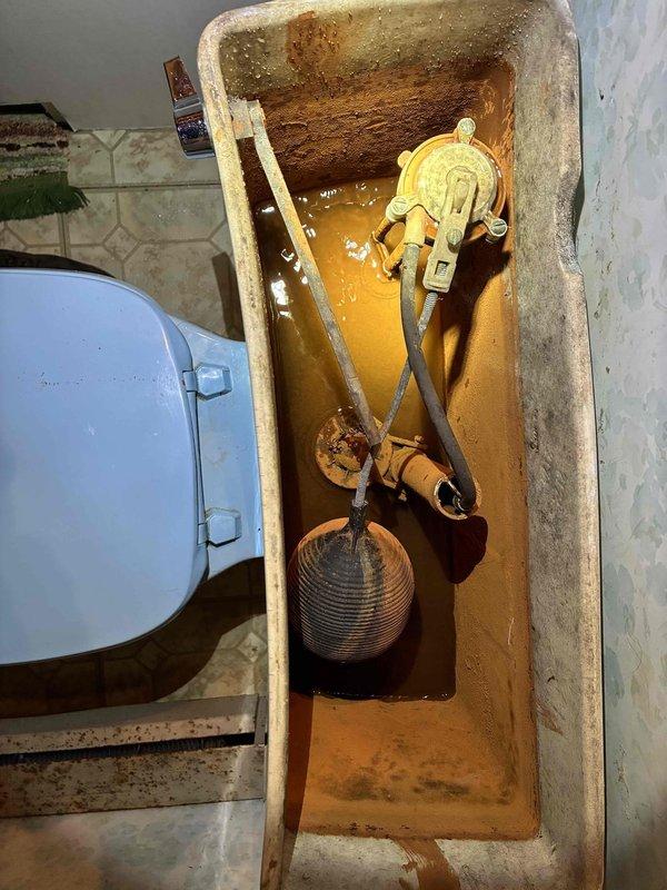Completed cottage de-winterization and opening service. Upon inspection, found existing toilet experiencing operational failure with severe internal rust contamination, mineral deposits, and corroded tank components including deteriorated fill valve assembly and compromised flapper mechanism. Removed and disposed of old toilet fixture. Installed new toilet unit to restore proper bathroom functionality and ensure reliable operation for the season.