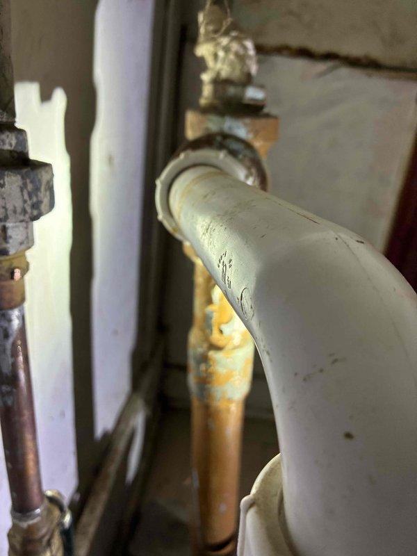 Completed cottage de-winterization and addressed plumbing issue in bathroom. Accessed property using provided key location and power box access per instructions. Upon inspection, identified failed P-trap under sink with active leak. Removed deteriorated white plastic P-trap assembly and installed new replacement trap, ensuring proper alignment and secure connections to drain tailpiece and waste line. Tested system for leaks and verified proper drainage function. All plumbing components now operational for seasonal use.