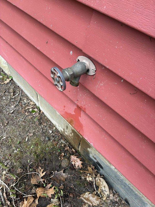 Completed cottage de-winterization service addressing multiple plumbing leaks. Replaced deteriorated utility sink faucet showing extensive corrosion and mineral buildup, installed new outdoor hose bib on exterior wall to eliminate leak at spigot, and replaced faulty water heater valve. All fixtures tested and verified operational with no leaks detected upon completion.