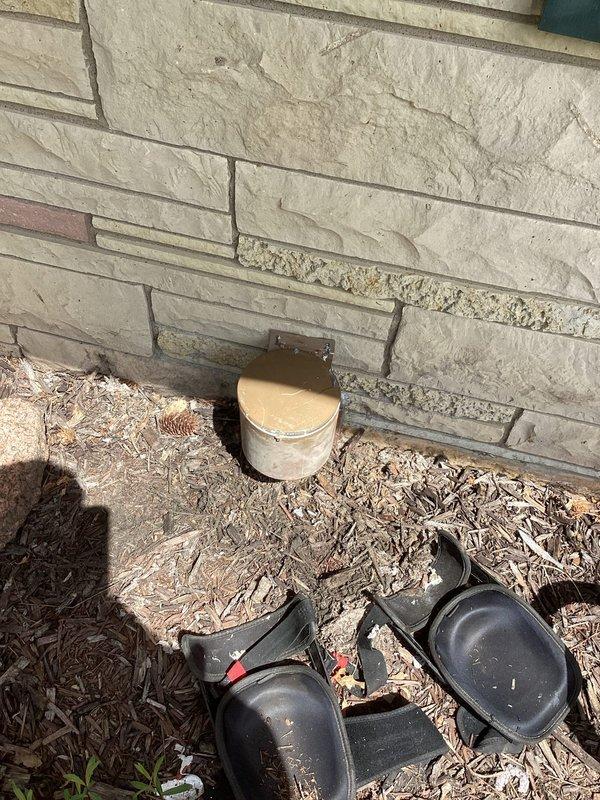 Responded to a workmanship recall for a dryer vent system that was completely disconnected from the exterior termination point, rendering the dryer inoperable. Upon arrival, confirmed the vent was fully detached from the wall termination. Discussed available repair options with the customer and proceeded with reconnection. Reattached the dryer vent ducting to the exterior termination fixture mounted on the stone veneer wall, securing all connections to restore proper venting function. Documented the repair with photographs showing the exterior termination point and completed work. System restored to operational status.