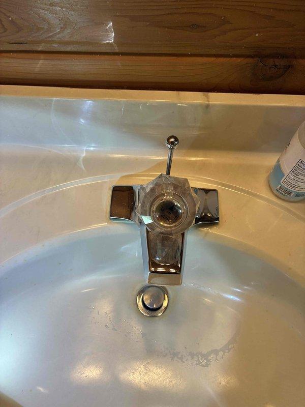 Completed cottage de-winterization service for two-bathroom property. Replaced leaky bathroom faucets with new chrome-finished single-handle units, restoring proper water flow and eliminating leaks in both locations.