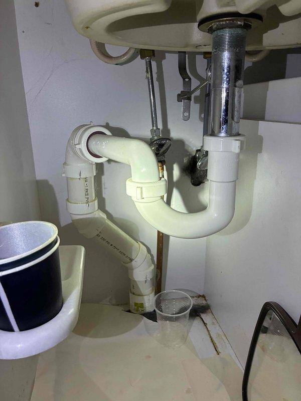 Completed cottage opening and de-winterization service for two-bathroom property. Inspected plumbing systems including under-sink configurations with PVC P-traps, garbage disposal unit, and supply lines in both bathrooms, confirming all connections were secure and operational. Advised customer that boiler was displaying error code requiring attention and recommended monitoring property for signs of pest activity during seasonal opening.