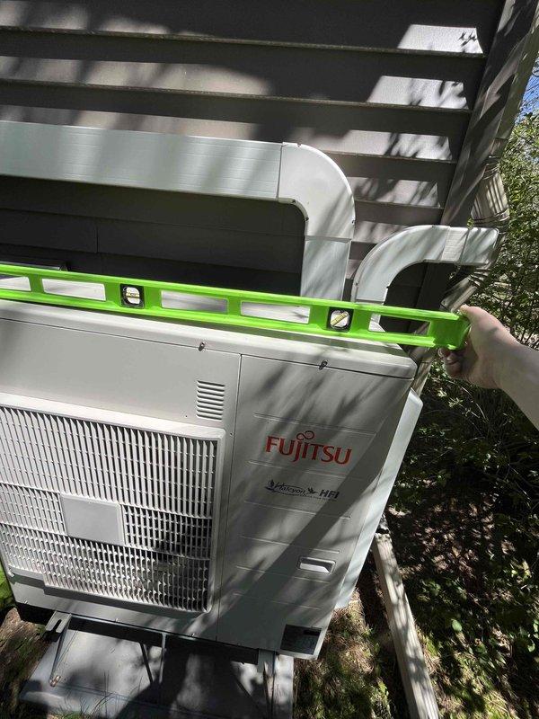 Performed site evaluation of Fujitsu condenser unit to assess leveling requirements and additional system improvements. Verified unit operation under full load conditions with no abnormal vibration or shaking observed. Checked condenser level positioning and documented current installation status. Identified exposed lineset section beneath deck requiring protective covers and condensate drain line causing deterioration to concrete slab surface. Prepared estimates for condenser leveling service, installation of lineset protection covers under deck area, and extension of drain line to redirect water discharge away from foundation.