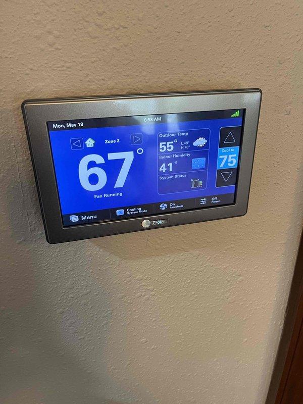 Completed partner plan inspection of AC/mini split system. Inspected blower wheel assembly and found unit operating properly with minimal dust accumulation on components. Verified thermostat functionality showing Zone 2 cooling system running correctly at 67°F with outdoor temperature at 55°F and indoor humidity at 41%. Examined condenser fins and noted very mild buildup present but no immediate cleaning required at this time. All system components functioning within normal parameters.