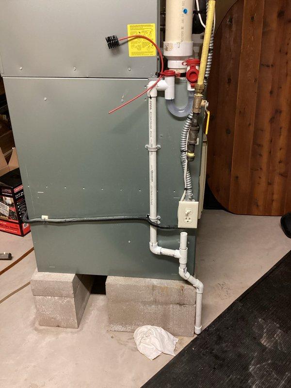 Replaced defective hard start kit at capacitor to restore proper compressor operation. Cleared and replaced clogged condensate drain line on furnace to ensure proper drainage and prevent water backup. System tested and confirmed operational upon completion.