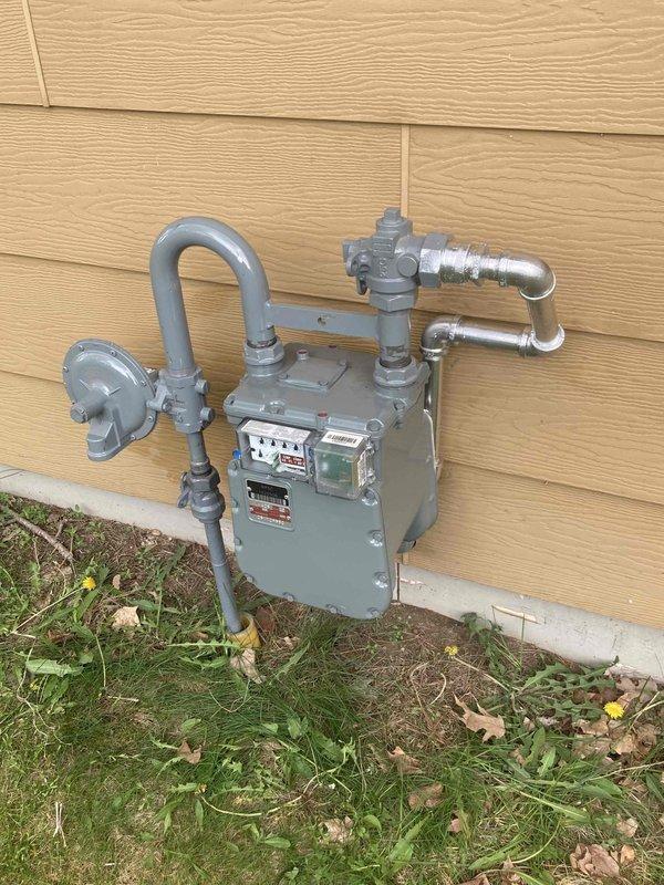 Installed a 199,000 BTU tankless water heater with integrated recirculation feature, complete with flush and service valves for future maintenance accessibility. Completed all electrical connections, domestic water piping within 10 feet of the unit, PVC vent pipe installation through exterior wall, and gas pipe connections to existing natural gas supply. The installation accommodated the property's total BTU load of approximately 324,000 BTU across all gas appliances including furnace, dryer, stove, and the new tankless unit.