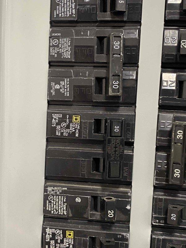 Responded to no cooling complaint and found tripped circuit breaker at electrical panel. Reset breaker to restore power to HVAC system and verified unit operation. Inspected air filter condition, which was found to be clean and properly installed.