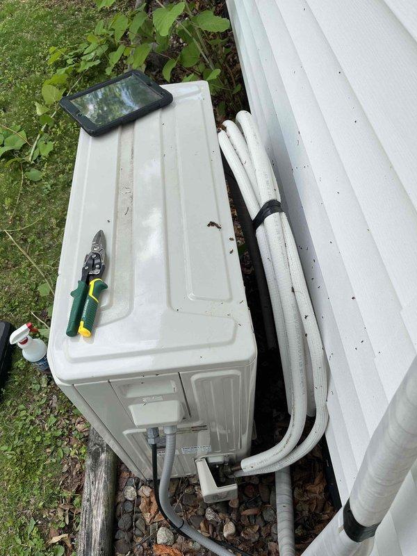 Responded to service call for two-year-old mini-split system running but not cooling properly. Performed diagnostic testing and confirmed low refrigerant levels through gauge readings, indicating a leak in the system. Documented equipment condition with photos and provided estimate for refrigerant leak repair.
