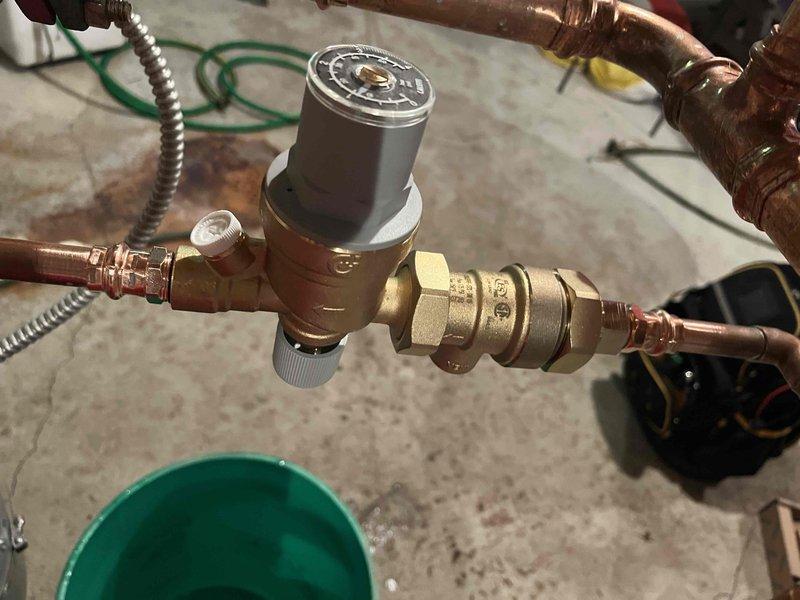 Responded to service call for broken backflow preventer and fill valve assembly on hydronic heating system. Removed failed brass backflow preventer/fill valve unit and replaced with new Caleffi backflow preventer and fill valve assembly, reconnecting copper supply lines with proper compression fittings. Verified system integrity and proper operation upon completion, ensuring water feed functionality was restored to heating system.
