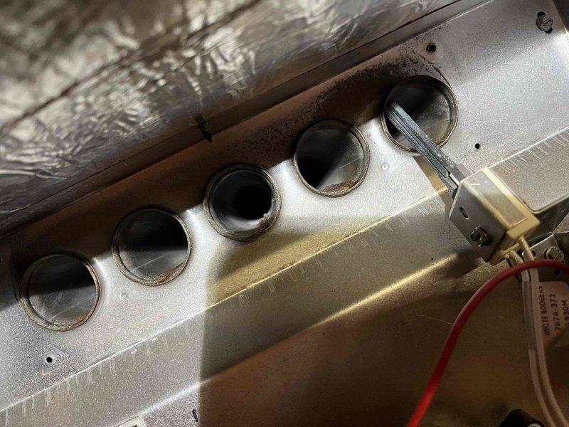 Completed annual partner plan inspection on furnace system. During inspection, identified blower run capacitor reading below acceptable specifications and noted moderate dust and debris buildup on blower wheel assembly affecting system efficiency. Documented conditions with photographs of heat exchanger ports showing dust accumulation and blower wheel with visible contamination on blades. Provided estimates for capacitor replacement and blower wheel cleaning to restore optimal system performance.