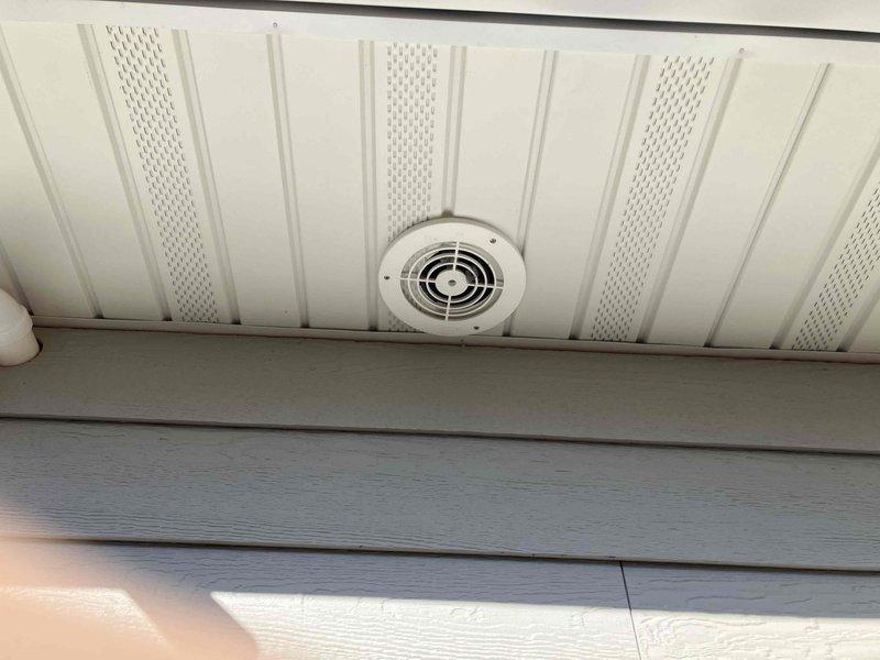 Conducted site assessment and provided estimate for furnace combustion air intake relocation and dryer vent modification. Current furnace air inlet located in attic is drawing blown-in insulation into system, requiring relocation to exterior termination point. Existing dryer vent terminates in soffit, creating moisture recirculation into attic space and presenting mold risk along with accessibility issues for maintenance. Recommended routing dryer vent through existing recessed area in sidewall for proper exterior termination. Estimate includes running necessary piping to rear of structure for furnace intake relocation and complete dryer vent reroute to eliminate soffit discharge point.