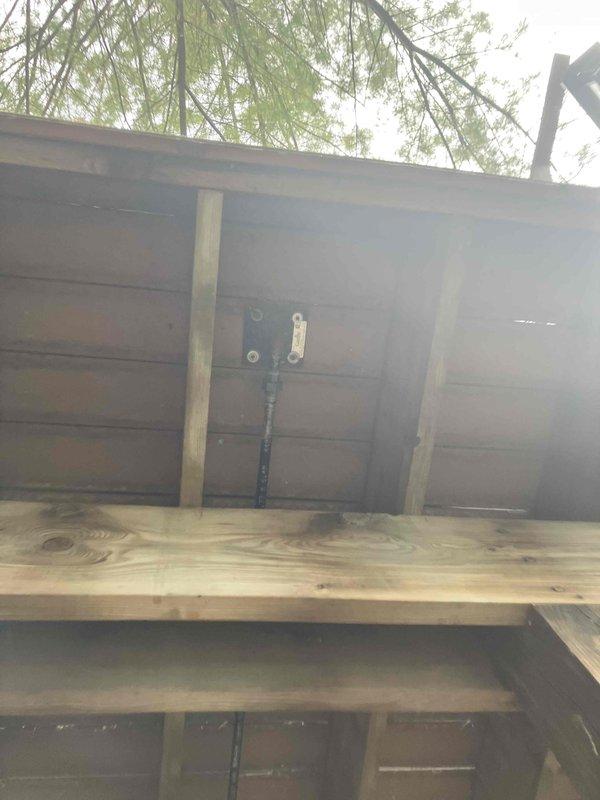 Approved and sold estimate for gas piping installation work. Inspected underside of deck structure where new gas line routing will be installed, documenting existing conditions including exposed joists, current utility runs, and available pathways for pipe installation. Photographed structural elements and clearances to finalize installation plan for natural gas piping project.