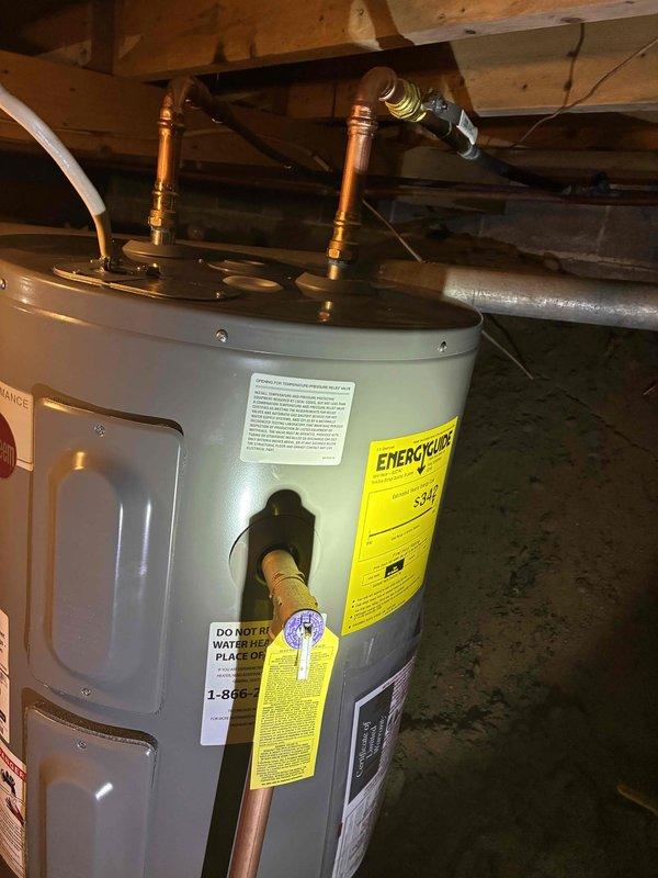 Completed electric water heater replacement in residential basement setting. Removed existing unit and installed new tanked electric water heater with proper electrical connections, water supply lines, and discharge piping. Verified all connections for leaks, tested unit operation, and confirmed proper temperature settings and safety features are functioning correctly.