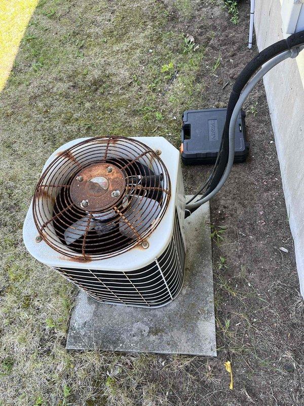 Responded to no cooling complaint on R-22 air conditioning system. Upon arrival, confirmed outdoor condenser unit was running but no cool air was being delivered to the living space. Performed diagnostic evaluation and discovered system was completely empty of refrigerant, indicating a leak in the system. The outdoor unit showed significant age-related corrosion and rust on the fan assembly and components, consistent with extended exposure to outdoor elements. Discussed troubleshooting and repair options with customer versus system replacement consultation. Customer elected to proceed with comfort advisor consultation to evaluate replacement options given the age of the equipment, R-22 refrigerant phase-out considerations, and current system condition.
