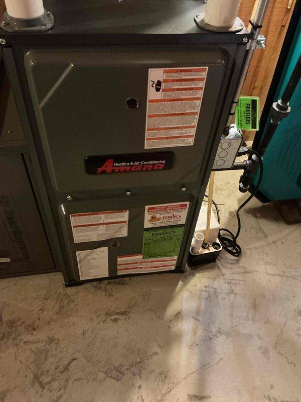 Completed comprehensive furnace inspection on Amana heating unit as part of prepaid maintenance plan. Performed thorough visual examination of cabinet exterior, verified all safety labels and warnings present and legible, and inspected venting configuration with dual PVC exhaust/intake pipes. Accessed internal components through control panel door to examine circuit boards, electrical connections, and wiring harnesses. All multi-colored wire connections found secure with no signs of overheating or damage. Electronic control boards operating within normal parameters with no fault codes present. Noted minor dust and fiber accumulation on internal components, typical for operational unit. Verified all system components operating according to manufacturer specifications with no deficiencies requiring immediate attention or repair. Unit found in good working condition with no service needs at this time. Documentation photos captured for service records.