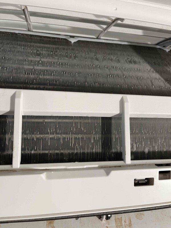 Responded to after-hours emergency service call for no cooling condition in bedroom mini-split head unit. Upon arrival, found indoor unit experiencing severe icing on evaporator coil with blower motor not operating. Confirmed 24V power supply present from outdoor condenser unit, but control board displayed no indicator lights or response. Visual inspection revealed heavily soiled evaporator coils with significant dust and debris accumulation restricting airflow. Documented internal components with photographs showing contaminated heat exchanger fins and overall unit condition. Diagnosed failed control board as primary cause of no-cool condition, with secondary contributing factor of restricted airflow due to lack of maintenance. Provided estimate for control board replacement and recommended professional coil cleaning to restore proper system operation and prevent future failures.