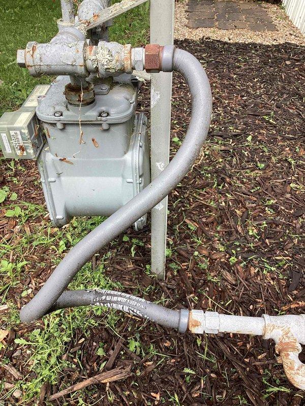 Completed repair work on HVAC system by replacing the blower assembly, inducer motor, and igniter to restore proper heating operation. Documented existing gas meter installation showing weathered flex gas piping connections between the gas main and home's supply line. Property owner requested estimate for converting flexible gas piping section to rigid hard pipe installation for improved durability and code compliance.