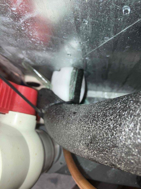Responded to no cooling complaint with loud noise operation. Upon arrival, found evaporator coil and condenser coil completely frozen with heavy ice accumulation. System was shut down to allow complete defrosting of coils before further diagnosis could be performed. Observed significant condensation on refrigerant lines and drain pan, indicating restricted airflow or potential refrigerant issue. Documented frozen coil conditions and compressor assembly for further evaluation once defrost cycle completes.